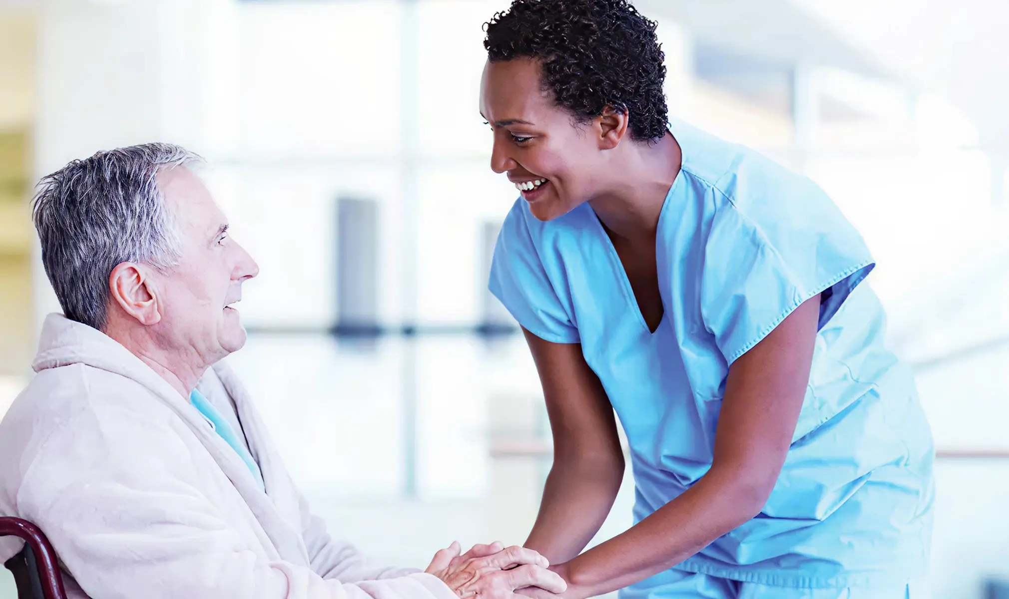 Nurse assisting elderly patient with care and support